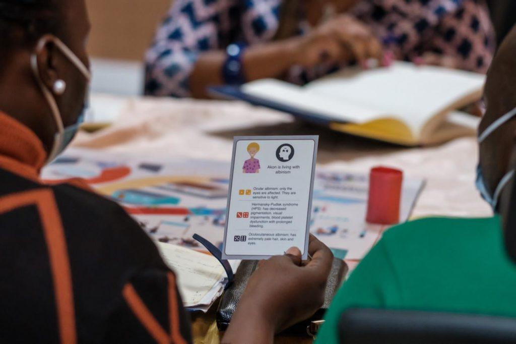 A lady holds up a card