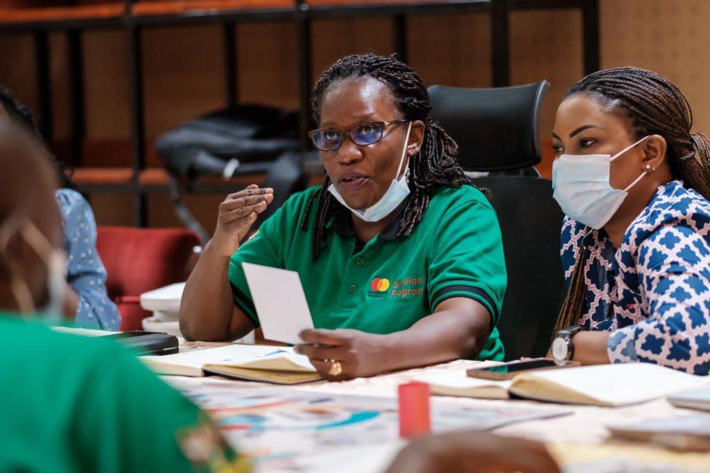 A lady speaks while others next to her listen