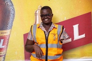 A photo of a man with a Physical impairment, left arm amputee, smiling wearing an orange vest